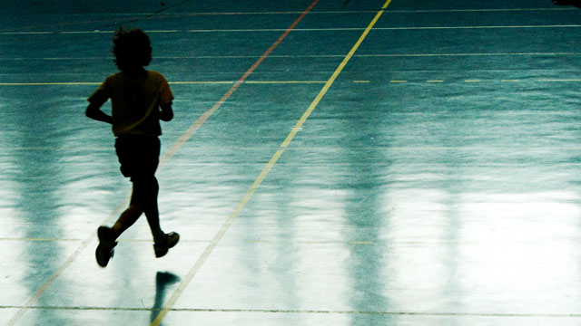 PHOTO: A young boy running on a basketball court.