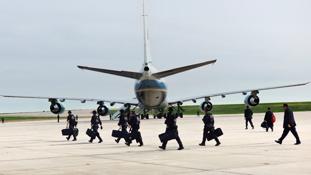 PHOTO: Members of the Secret Service and other staff walk behind Air Force One at Buckley Air Force Base, April 25, 2012 in Colorado.