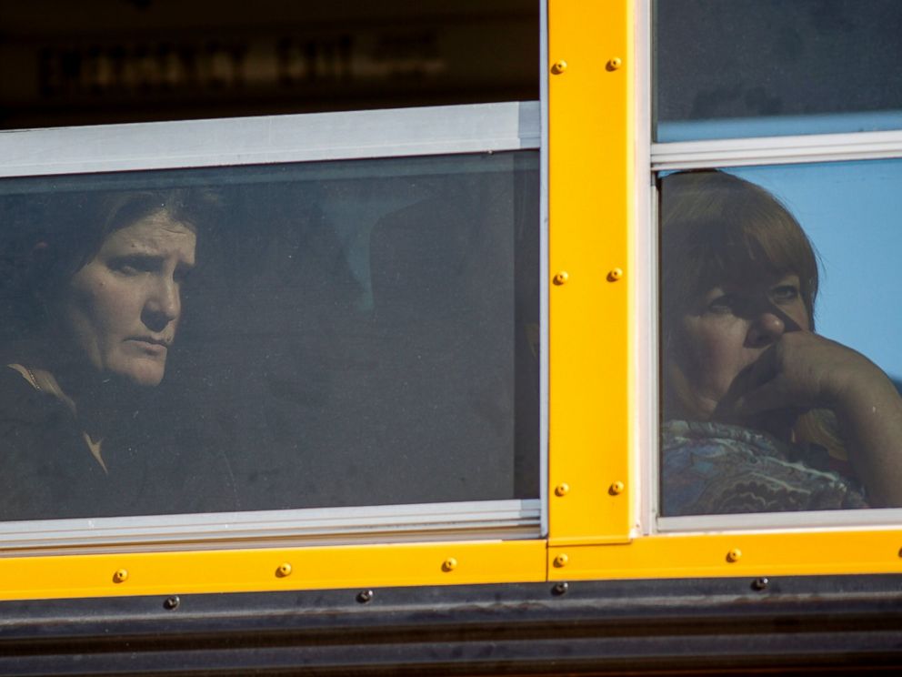 PHOTO: Employees and other people are evacuated by bus from the site of a mass shooting at the Inland Regional Center Dec. 2, 2015 in San Bernardino, Calif.