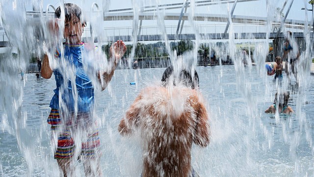 PHOTO: Ten-year-old Lilly Hwang-Geddes (L) of Ithaca, New York, plays in a fountain at the Yards Park July 5, 2012 in Washington, DC.
