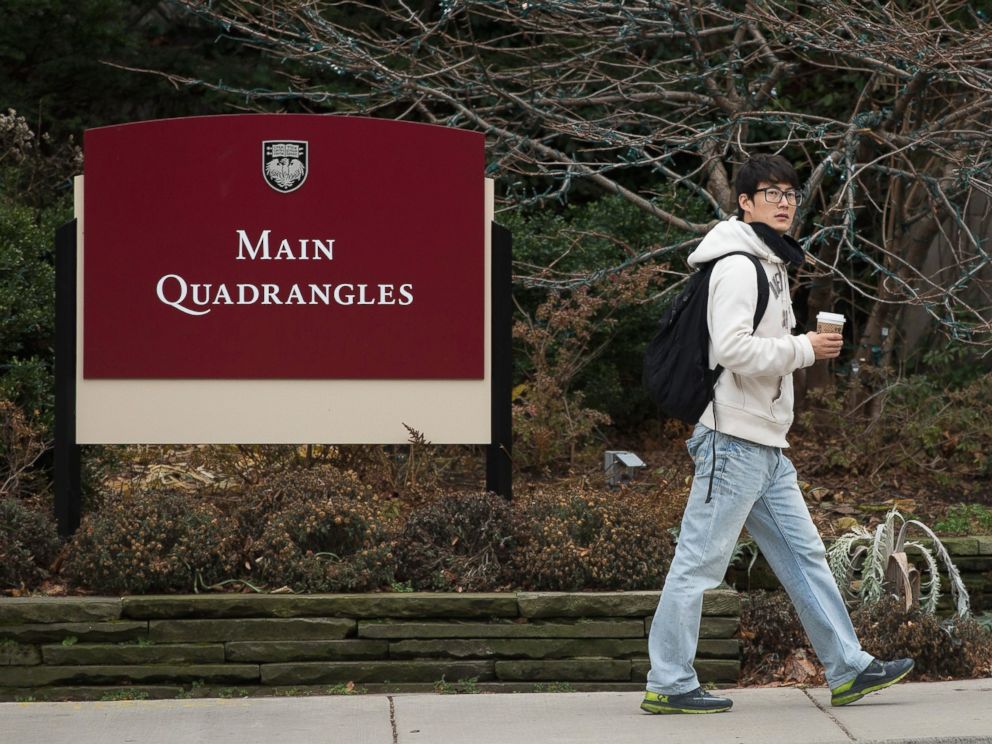 PHOTO: Pedestrians walk past an entrance to the main quad on the Hyde Park Campus of the University of Chicago on Nov. 30, 2015 in Chicago.