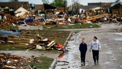 PHOTO: A woman and young boy walk along a street, May 21, 2013, in Moore, Okla.