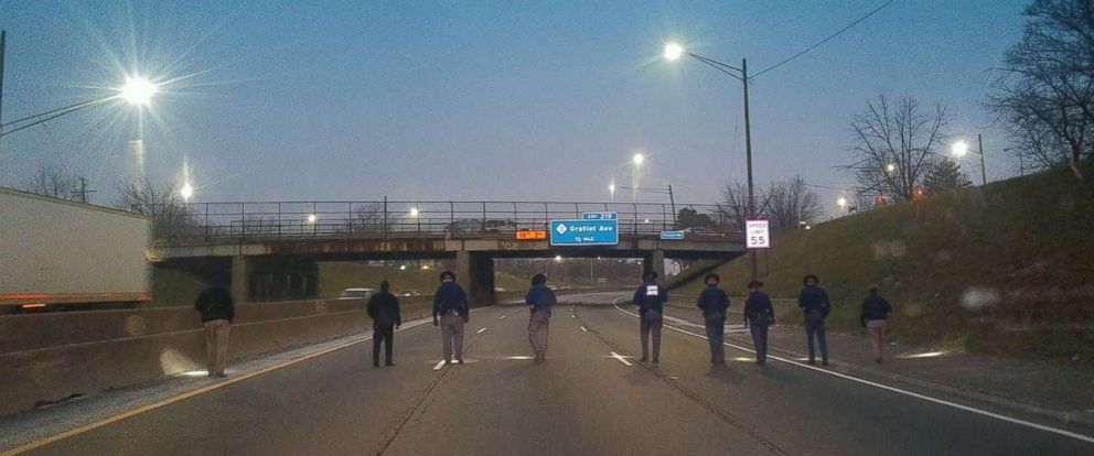 Michigan State Police comb I-94 for evidence Thursday morning after a series of shootings in the Detroit area.