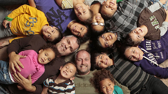 PHOTO: Roger and Steven Ham are surrounded by their 12 adopted children.