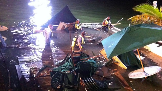 PHOTO: Divers search the water after a deck collapse at Shuckers Bar & Grill in Miami Thursday night, June 13, 2013.