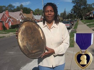Gail Embery holds a picture of her father, Sgt. Coleman Edwards