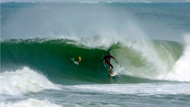 PHOTO: Hurricane chaser Shea Lopez surfing a hurricane swell in 2008. He is following Hurricane Irene through the East Coast and looking for areas where waves are between 10 and 20 feet.