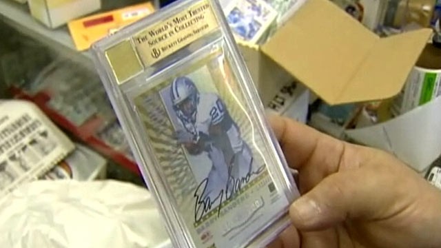 PHOTO: Todd and Ula Nelkin of Houston, Tex., are auctioning a one-of-a-kind, double autographed football card of Barry Sanders and Walter Payton in order to pay for a last attempt at IVF.