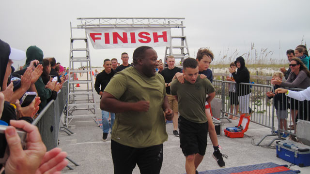 PHOTO: Ben Baltz, an 11-year-old boy who lost his leg to bone cancer, is carried across the finish line by Private First Class Matthew Morgan, a Marine stationed at Corry Station who was helping supervise a childrens triathlon in Pensacola, Fla. on Octob