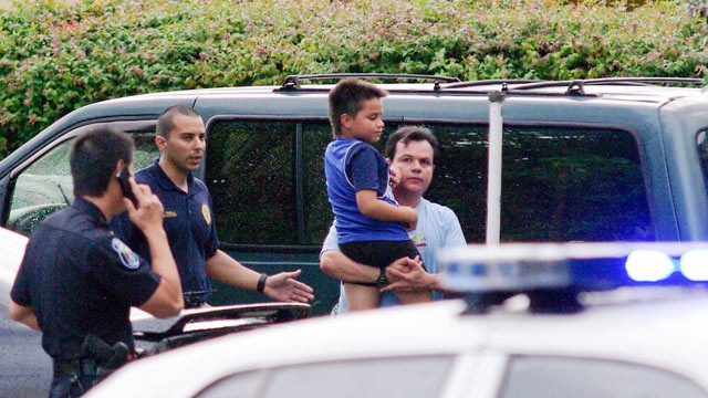 PHOTO: Escorted by Hollywood police, Luis Gutierrez Sr. carries his son Luis Gutierrez Jr. away from their home after a foiled robbery that had Luis Gutierez Jr. pinned beneath his bed until police arrived in Hollywood.