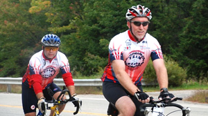 PHOTO Parkinsons patient, Chris Woods, right, rides in a 100 mile New England Parkinson?s Ride.