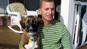 PHOTO Corporal Mike Lemmons and his dog Ally. Lemmons and his fellow soldiers deployed in Afghanistan found Ally abandoned in a battlefield, and arranged for her transport to the U.S.