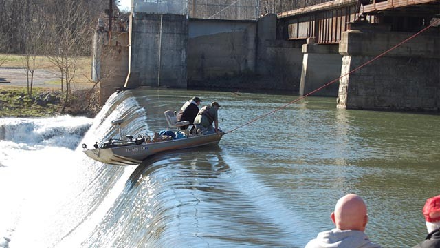 Greg and Gary Cherry are shown in a boat dangling over a dam at Pepper 