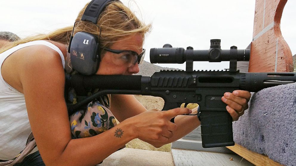 PHOTO: Woman firing rifle at gun range