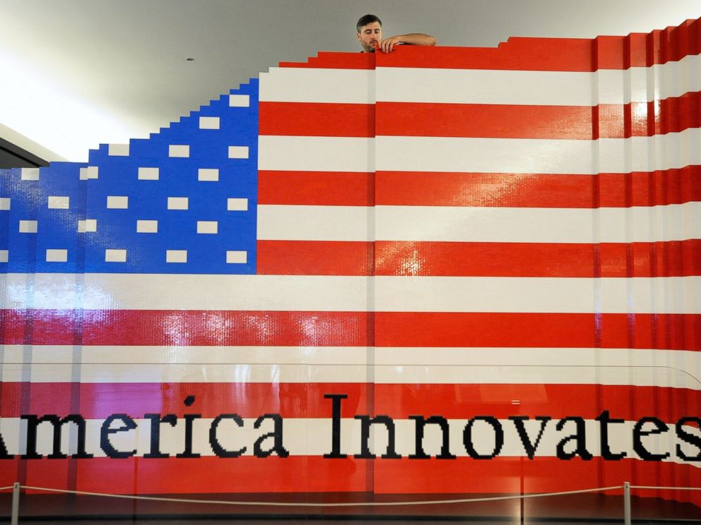 PHOTO: LEGO master builder Chris Steininger places a brick while building the worlds largest LEGO American flag.