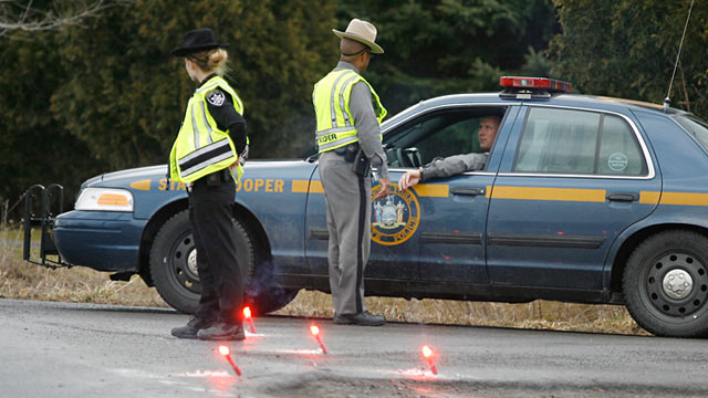 Photo: New York State Troopers and a Madison County Sheriffs deputy block off John Peet Road, outside Canastota, N.Y.
