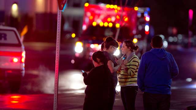 PHOTO: People watch and wait for their friends and family to be released from the Clackamas Town Center mall after a gunman killed two people, Clackamas, Oregon, Dec 11,2012.