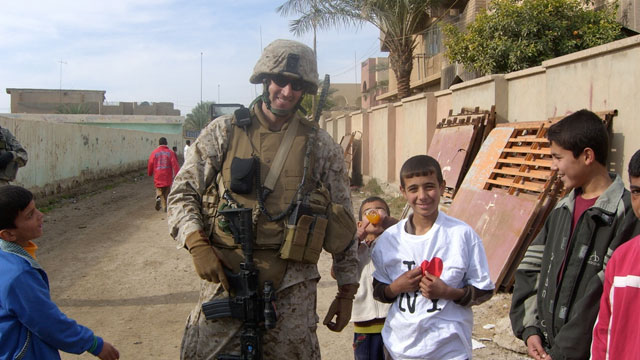 PHOTO: Owen West, Managing Director at Goldman Sachs poses with a young boy in Khalidiya, Iraq. Goldman Sachs Commodities team sponsored West?s Iraqi battalion, raising money as individuals, and donating goods. West said the ?I heart New York? T-shirt was