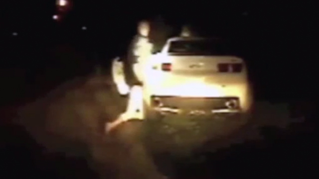 PHOTO: Police officer banging womans head on car