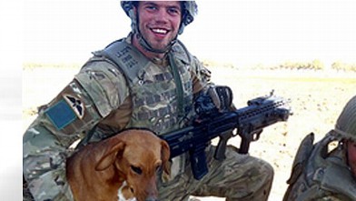 PHOTO:Pte. Conrad Lewis from the 4th Battalion, Parachute Regiment, is shown with his dog, Pegasus.