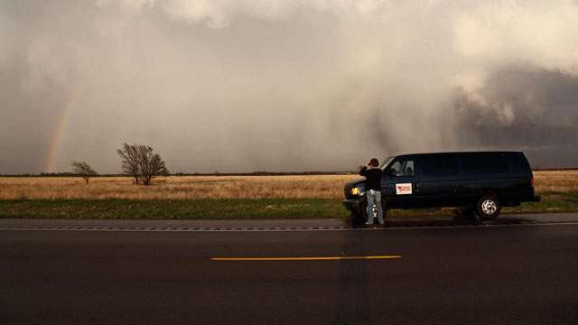 PHOTO: A member of a tornado tour steps outside the van to capture the storm, April, 2009.