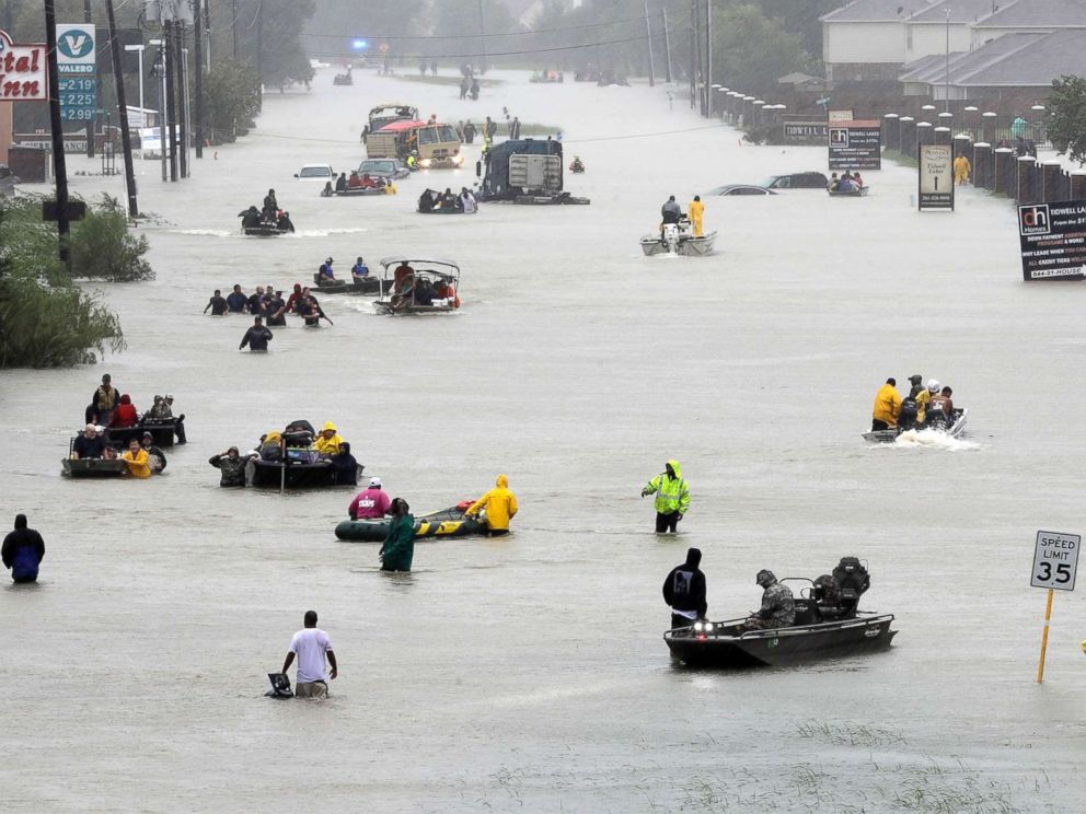 PHOTO: Rescue boats fill a flooded street at flood victims are evacuated as floodwaters from Harvey rise\, Aug. 28\, 2017\, in Houston. 