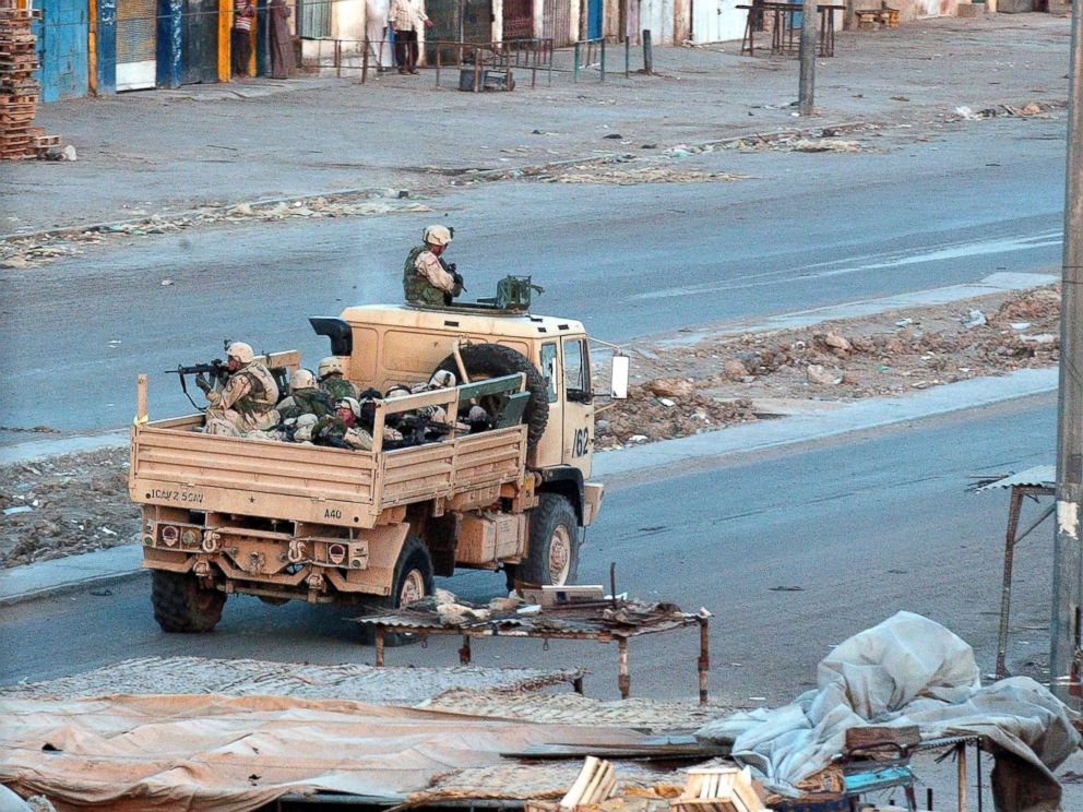 PHOTO: U.S. troops patrol the deserted streets of the sprawling Shia slum of Sadr City at sunset after a day of tense clashes across the country with supporters of controversial Shia cleric Moqtada al-Sadr, April 4, 2004, in Sadr City, Iraq. 