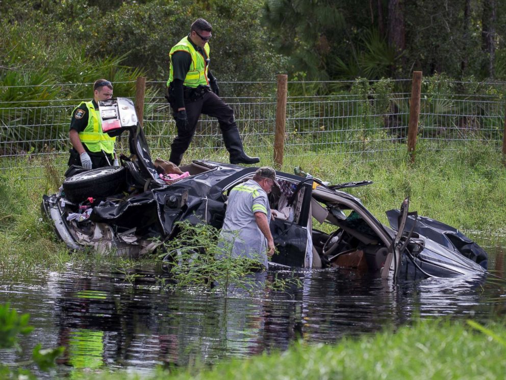 PHOTO: Police officers climb atop a vehicle while trying to salvage it from the aftermath of Hurricane Irma in North Port, Fla., Sept. 11, 2017.