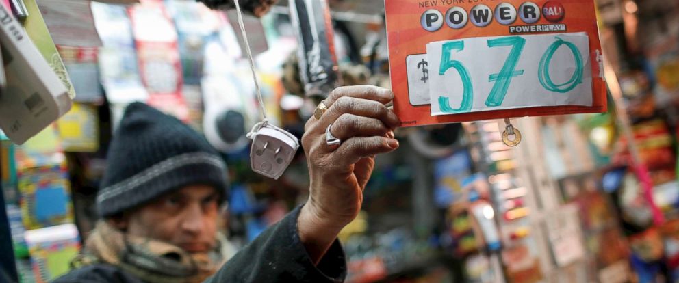PHOTO: A vendor who sells lottery tickets hangs a sign for the Powerball drawing at a news stand in midtown Manhattan, Jan. 5, 2018.