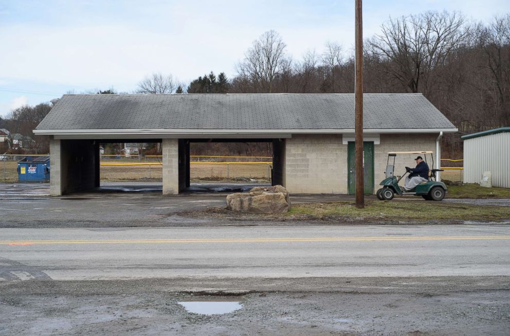 PHOTO: A man rides a golf cart past Eds Car Wash where several people were found dead and one injured after a shooting, Jan. 28, 2018 in Melcroft, Pa.