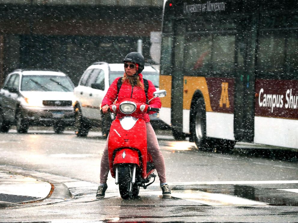 PHOTO: A commuter braves the first snow of the season on a scooter in the West Bank, in Minneapolis, Oct. 27, 2017. 
