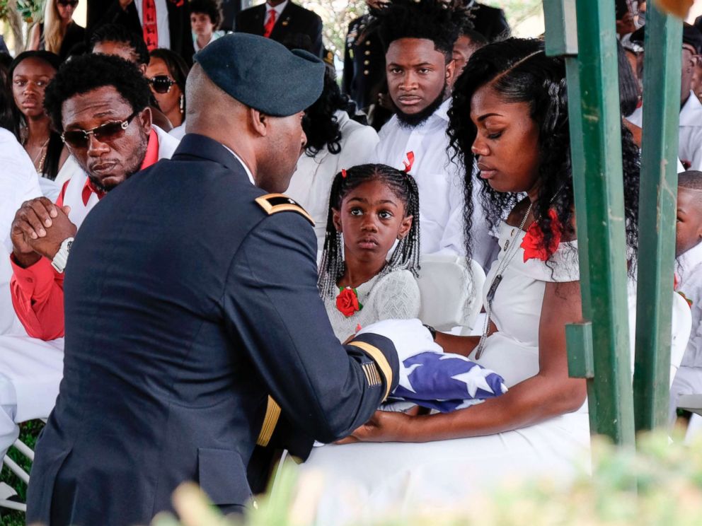 PHOTO: Myeshia Johnson is presented with a folded U.S. flag by a military honor guard member during the burial service for her husband U.S. Army Sgt. La David Johnson at the Memorial Gardens East cemetery, Oct. 21, 2017, in Hollywood, Fla.
<p itemprop=