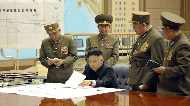 PHOTO: An unverified photo released by KCNA news agency on March 29, 2013 shows top leader of the Democratic People s Republic of Korea (DPRK) Kim Jong Un (seated) attending an urgent meeting with top military officials; Un has reportedly ratified a strik