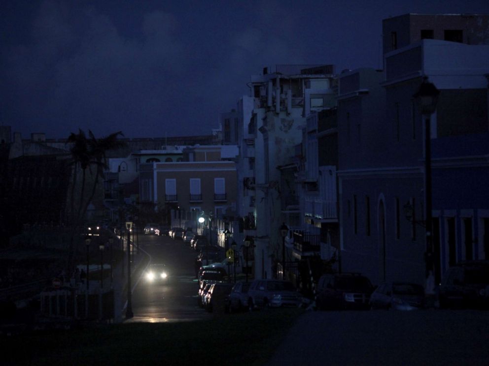 PHOTO: A car drives through a dark street in Old San Juan, Puerto Rico, Oct. 26, 2017, after Hurricane Maria hit the island and damaged the power grid in September.