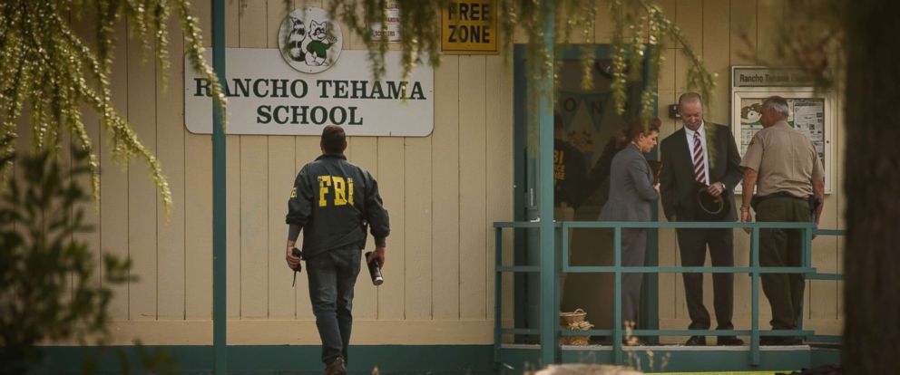 PHOTO: FBI agents are seen behind yellow crime scene tape outside Rancho Tehama Elementary School after a shooting in the morning on Nov. 14, 2017, in Rancho Tehama, Calif.