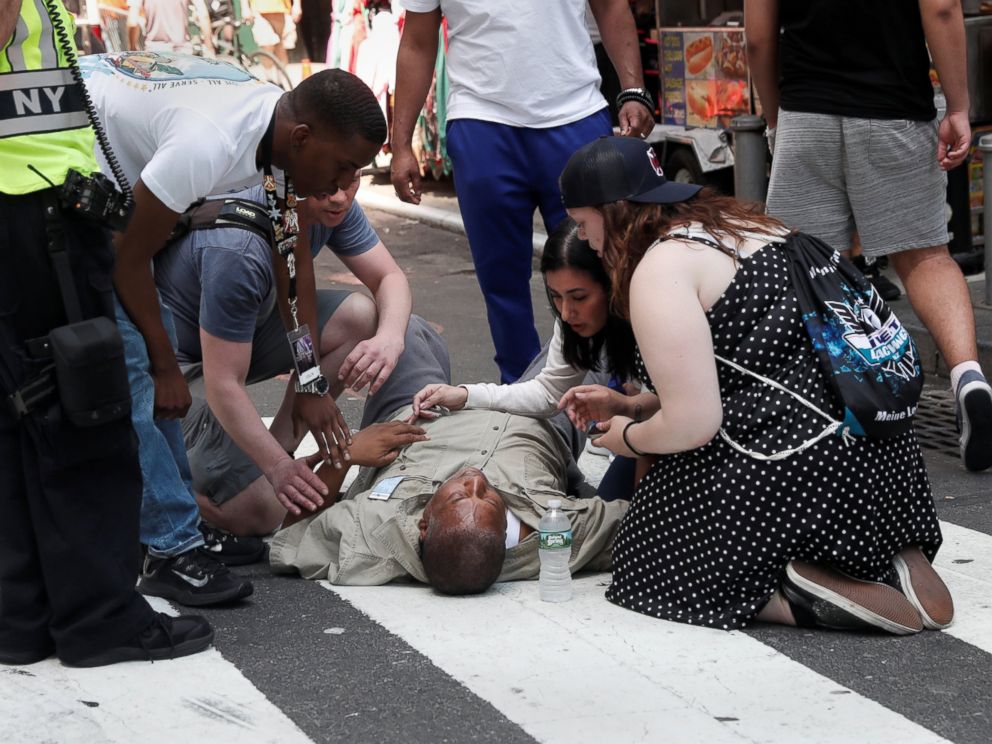 PHOTO: An injured man is helped on the sidewalk in Times Square after a speeding vehicle struck pedestrians on the sidewalk in New York City, May 18, 2017.