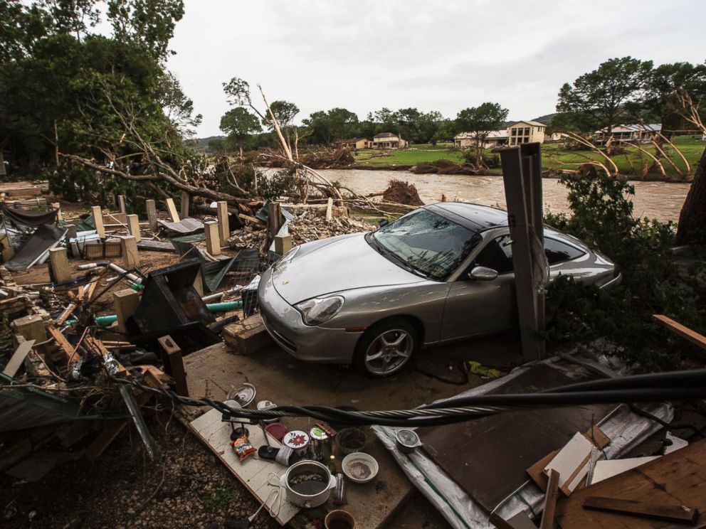 PHOTO: A Porsche rests against the foundation of a home destroyed by the Memorial Day weekend floods in Wimberley, Texas, May 26, 2015.