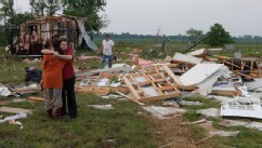 PHOTO: Leah Hill (L), of Shawnee, Oklahoma, is hugged by friend Sidney Sizemore, as they look through Hill's scattered belongings from her home which was destroyed by a tornado, west of Shawnee, Oklahoma May 19, 2013.