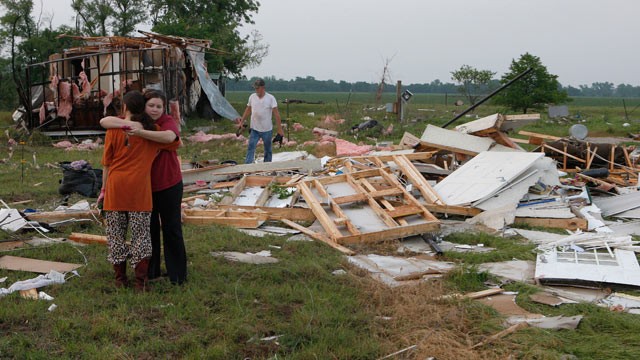 PHOTO: Leah Hill (L), of Shawnee, Oklahoma, is hugged by friend Sidney Sizemore, as they look through Hill's scattered belongings from her home which was destroyed by a tornado, west of Shawnee, Oklahoma May 19, 2013.