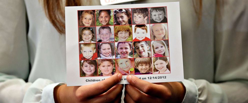 PHOTO: Kyra Murray holds a photo showing victims of the shooting at Sandy Hook Elementary School during a press conference at the U.S. Capitol calling for gun reform legislation, Sept. 18, 2013, in Washington, D.C. 