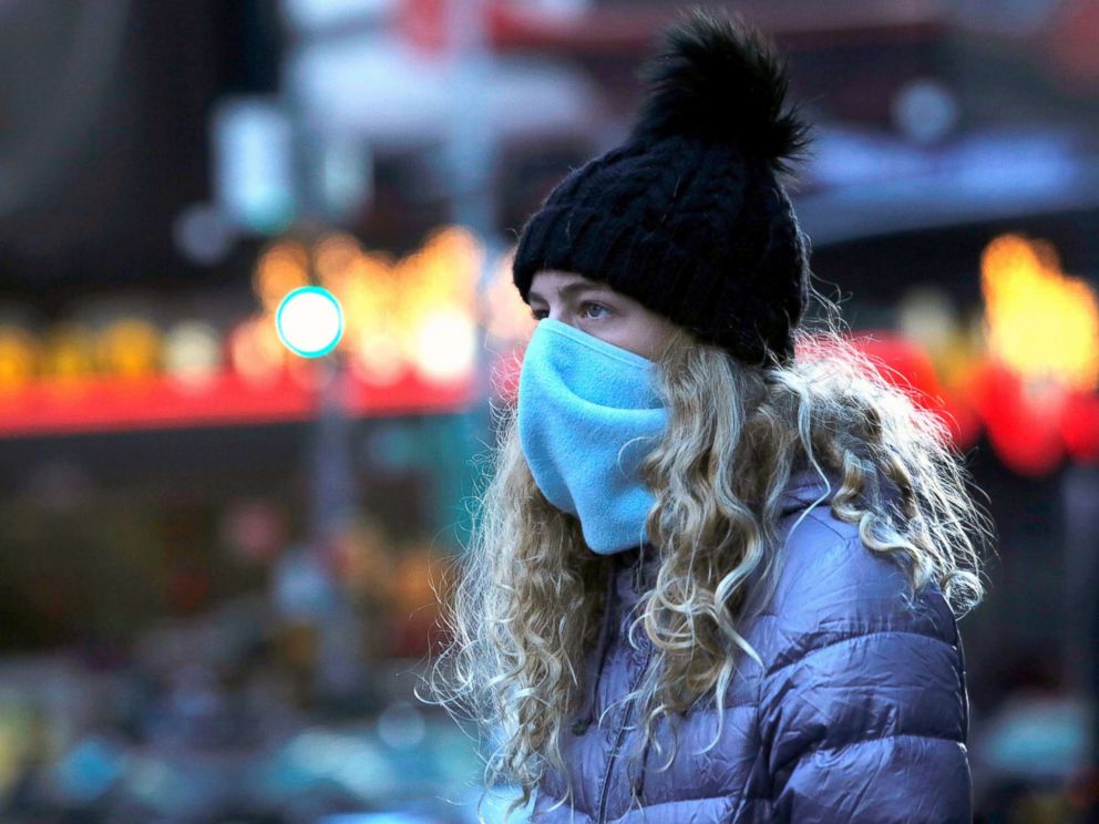 PHOTO: Tourist Ava Black of West Palm Beach in Fla. walks through Times Square as a cold weather front hits the region in Manhattan, in New York City, Dec. 29, 2017.