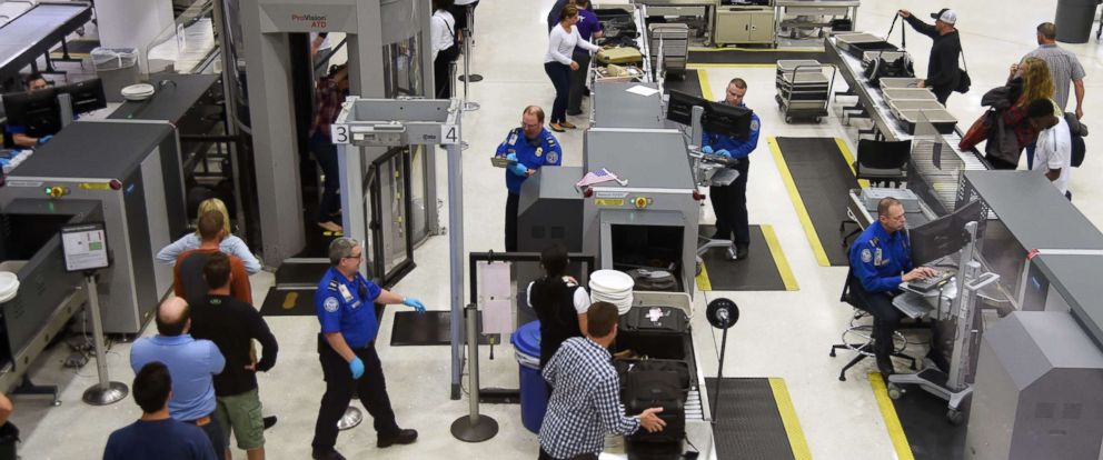 PHOTO: US Transportation Security Administration (TSA) officers inspect airline passengers before they board their flights, at Lambert St. Louis International Airport in St Louis, Missouri, Oct. 10, 2016. 