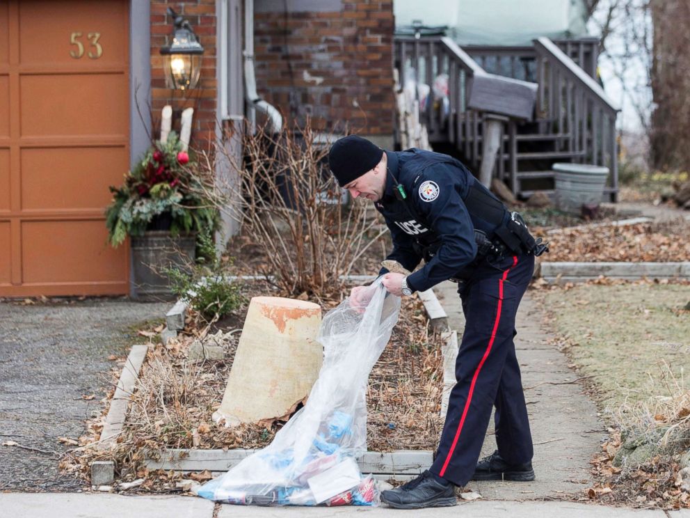 PHOTO: A police officer investigates outside a house on Mallory Crescent in Toronto, Jan. 29 , 2018.