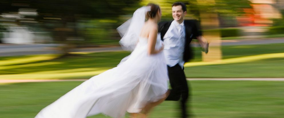 PHOTO: Bride and groom is running side by side in this stock image. 