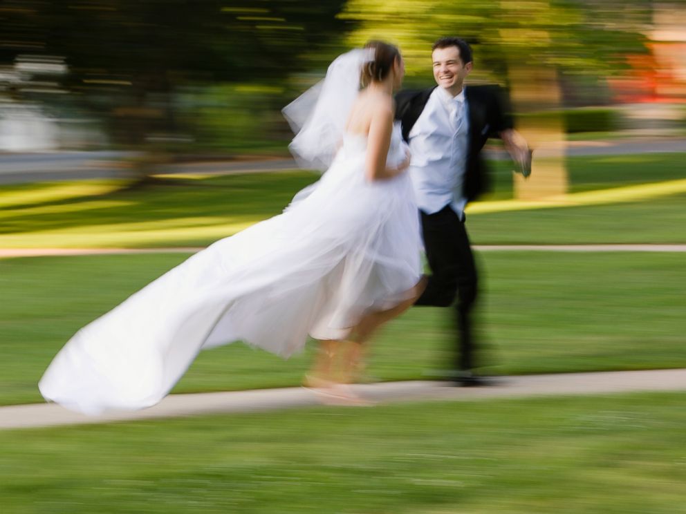 PHOTO: Bride and groom is running side by side in this stock image.