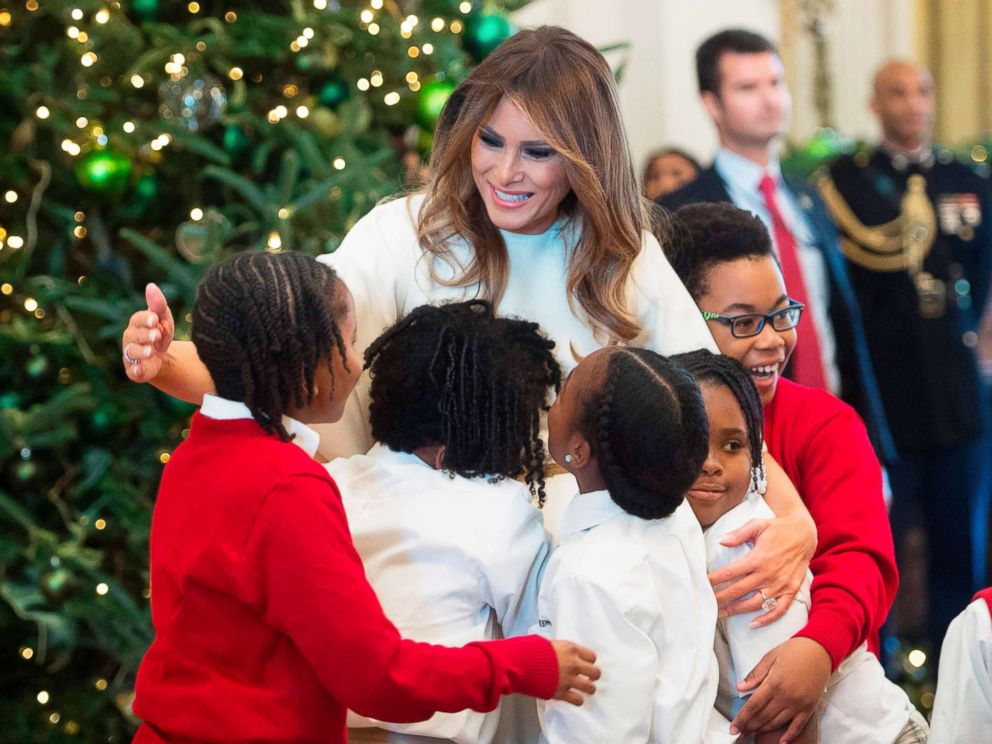 PHOTO: First Lady Melania Trump hugs children in the East Room as she tours Christmas decorations at the White House, Nov. 27, 2017. 