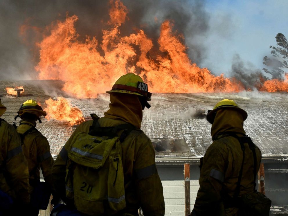 PHOTO: Firefighters battle to save one of many homes from a wildfire in Sylmar, Calif., Dec. 5, 2017. 