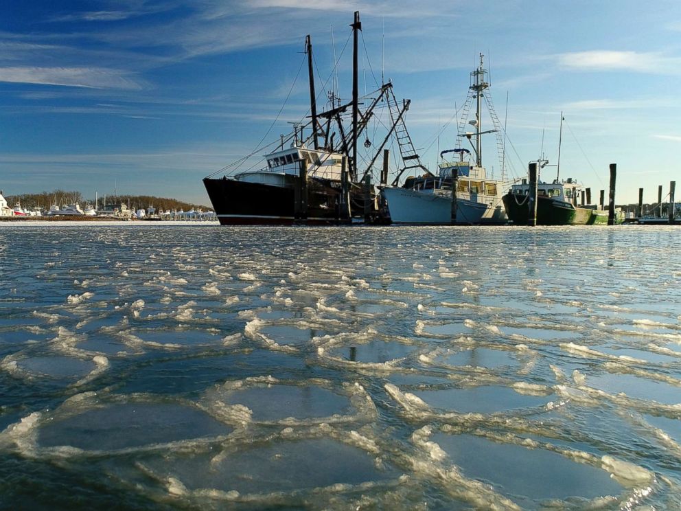 PHOTO: Fishing trawlers sit on the frozen harbor of Lake Montauk surrounded by thin sheets of ice, Jan. 7, 2018, in Montauk, N.Y. 