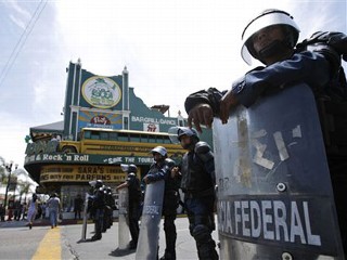 Federal police officers stand on guard in a street of Tijuana.