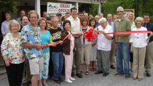 PHOTO Forrest Graves, center, with sunglasses, at the opening of his family-run business, JumpinGoat Coffee, in Helen, Ga.